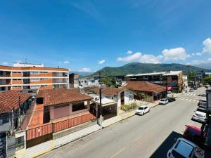 a view of a city street with buildings and cars at Ap Aconchego 210 B in Ubatuba