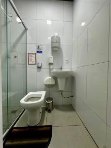 a bathroom with a toilet and a sink at Hostel Salazar in Campo Grande