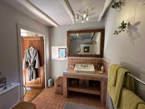 a bathroom with a sink and a mirror at Moulin de Latreille in Calès