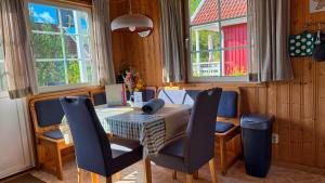 a dining room with a table and chairs and windows at Useriner Ferienhaus in Userin