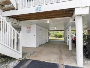 an empty garage with a car parked in it at Latitude 107 2 bedroom walk to beach in Orange Beach