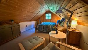 a bedroom with a bed and a table in a room at Useriner Ferienhaus in Userin