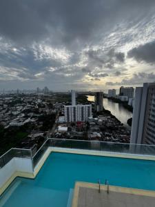 a swimming pool on top of a building with a city at Alessandro estilo italiano in Cartagena de Indias