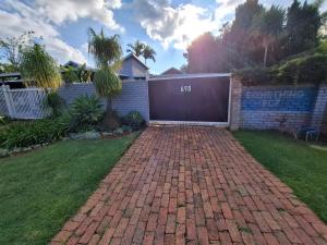 a brick driveway in a yard with a garage at SomethingElz@Grace in Pretoria