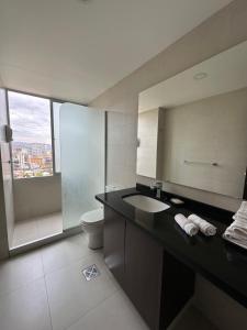 a bathroom with a sink and a toilet at Paseo Recoleta in Cochabamba +61 photos