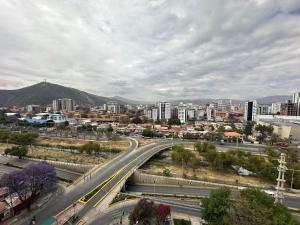 a view of a city with a highway and buildings at Paseo Recoleta in Cochabamba