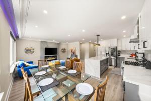 a kitchen and living room with a table and chairs at 5 Bedroom Luxury Spa Escape with Pool & Jacuzzi in Toronto
