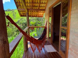 a hammock on the porch of a house at Refúgio Horse in Santo Antônio do Pinhal