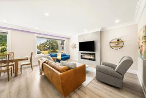 a living room with a couch and a fireplace at 5 Bedroom Luxury Spa Escape with Pool & Jacuzzi in Toronto