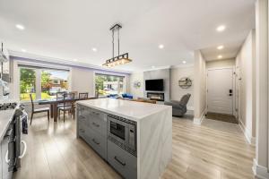 an open kitchen and living room with a dining room at 5 Bedroom Luxury Spa Escape with Pool & Jacuzzi in Toronto +28 photos