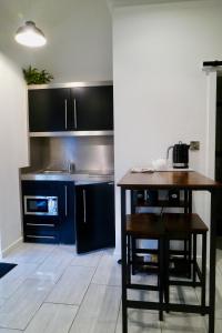 a kitchen with blue cabinets and a wooden table at The Mews & Studio in Ivybridge