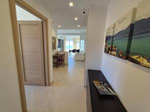 a hallway with a living room and a dining room at Alloggio Ametista frontemare con posto auto in Lavagna