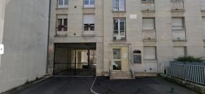 a building with a gate in front of it at Studio moderne au cœur de Compiègne in Compiègne