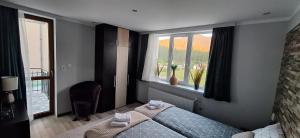 a bedroom with a bed and a window at Stoykite view in Stoykite