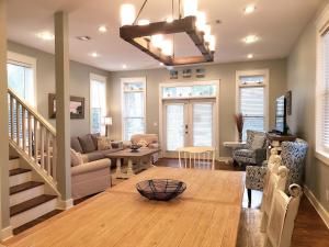 a living room with a couch and a table at Sea La Vie , Walk Everywhere in Rosemary Beach