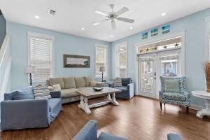 a living room with a couch and a table and chairs at Sea La Vie , Walk Everywhere in Rosemary Beach