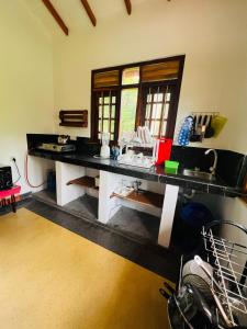 a kitchen with a long counter in a room at Jungle view one bedroom apartment in Unawatuna