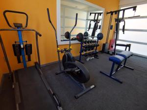 a gym with several exercise equipment in a room at Villa platino in Pachuca de Soto