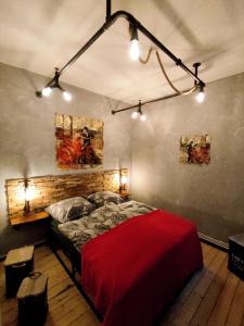 a bedroom with a red bed and two paintings on the wall at Altstadtblick Altenburg in Altenburg
