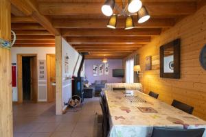 a dining room with a table and a couch at Chalet Edliane in Font-Romeu-Odeillo-Via