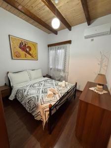 a bedroom with a bed and a dresser and a table at NoMad House-entire house at your disposal,4 guests in Berat