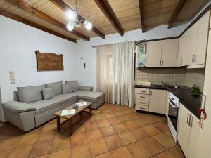 a living room with a couch and a kitchen at NoMad House-entire house at your disposal,4 guests in Berat
