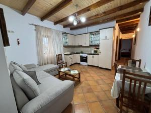 a living room with a couch and a kitchen at NoMad House-entire house at your disposal,4 guests in Berat