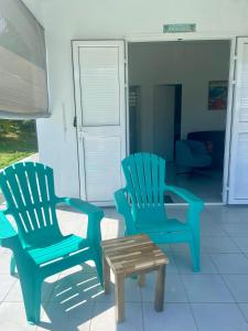 two chairs and a coffee table in a living room at Mango-passion Le Domaine Mannou in Sainte-Rose