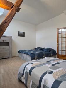 a bedroom with a bed and a dresser in it at Gîte entre vigne et loire Sancerre Amigny in Sancerre