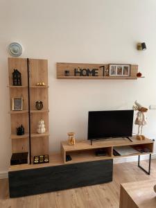 a living room with a tv on a wooden entertainment center at Dolce Vita in Belgrade +50 photos