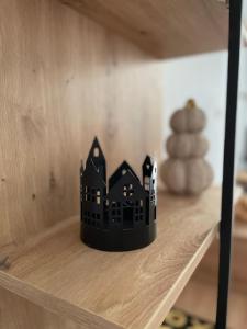 a black toy house sitting on a shelf with a pyramid at Dolce Vita in Belgrade