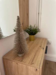 a wooden table with a small christmas tree on it at Dolce Vita in Belgrade