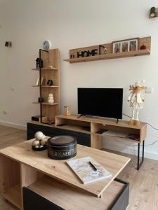 a living room with a television on a wooden table at Dolce Vita in Belgrade