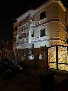 a building with a gate in front of it at night at Super Luxury Private Complex Apt In New Cairo in New cairo