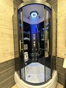 a bathroom with a shower with a blue light at Super Luxury Private Complex Apt In New Cairo in New cairo +54 photos