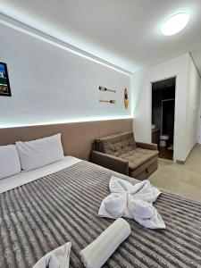 a bedroom with a bed with a white bow on it at Luxuoso e sofisticado Beach Class Verano by HM in Ipojuca +41 photos