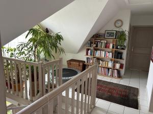 a staircase with a book shelf with books at Chez Corinne et Michel in Saasenheim