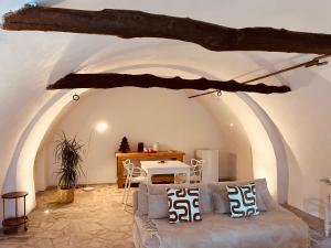 a living room with a couch and a table at La demeure des vignes in Murato