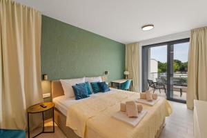 a bedroom with a large bed and a balcony at Villa 7Eight Banjole in Banjole +37 photos