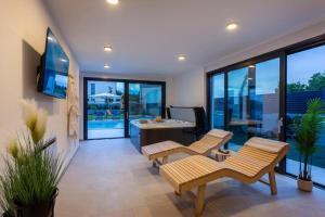 a living room with two chairs and a pool table at Villa 7Eight Banjole in Banjole