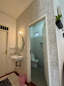 a bathroom with a sink and a toilet at Villa puncak 3 room in Cikundul +4 photos