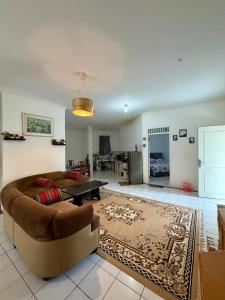 a living room with a couch and a table at Villa puncak 3 room in Cikundul