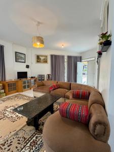 a living room with a couch and a table at Villa puncak 3 room in Cikundul