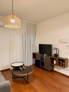 a living room with a couch and a table at Relax Beach Apartment in Larnaca