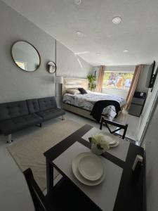 a bedroom with a bed and a table with plates on it at Private Studio with Patio-King Bed, Near Beach & Casinos in Hollywood