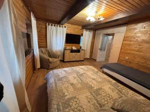 a bedroom with a bed and a tv in a room at Gastehaus in Kostyantynivka