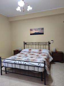 a bedroom with a bed with a metal frame at Il Melograno in Terzigno
