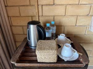 a coffee table with a coffee pot and water bottles at Beach Garden in Weligama