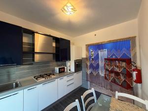 a kitchen with a sink and a stove top oven at Casa Raffinata in Mestre
