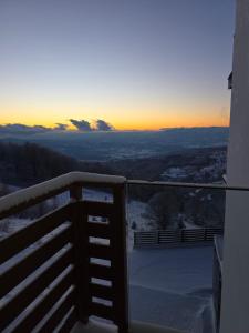 a view of the sunset from the balcony of a house at Sky Nest Kopaonik in Kopaonik